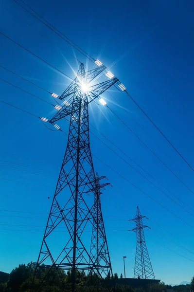 Electricity pylon against the light