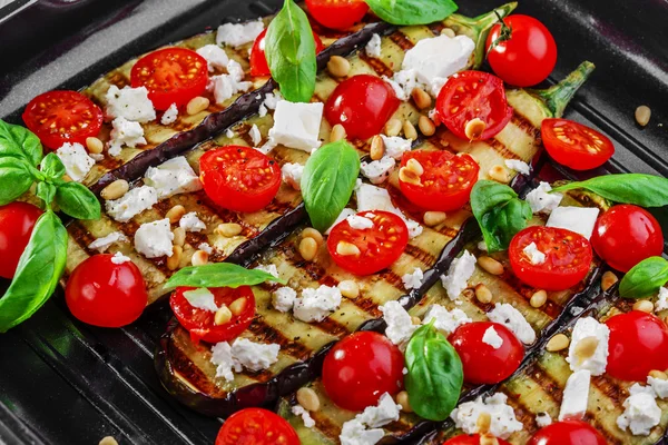 Grilled eggplant with feta cheese and cherry tomatoes