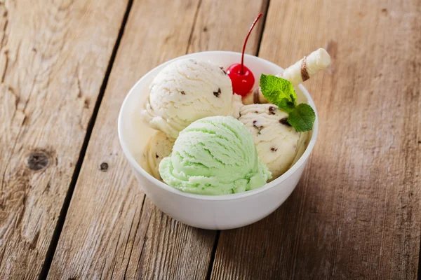 Ball pistachio and white ice cream in a bowl