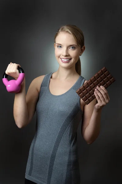 Model with pink kettlebell and chocolate