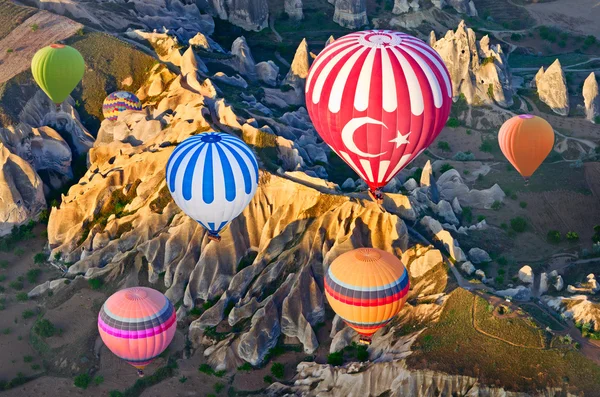 Hot air balloons over mountain landscape