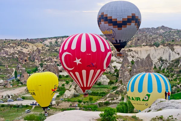 Hot air balloons over mountain landscape