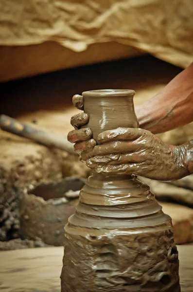 Potter creating earthen jar
