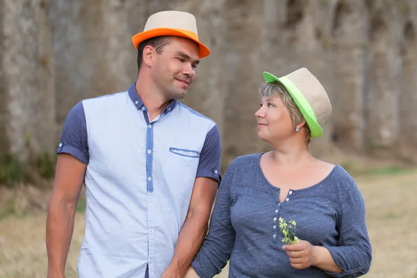 Portrait of happy married couple in hats