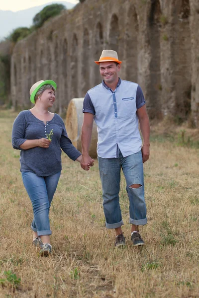 Portrait of happy married couple in hats