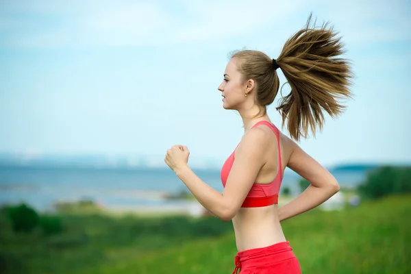 Young woman running summer park rural road. Outdoor exercises. J