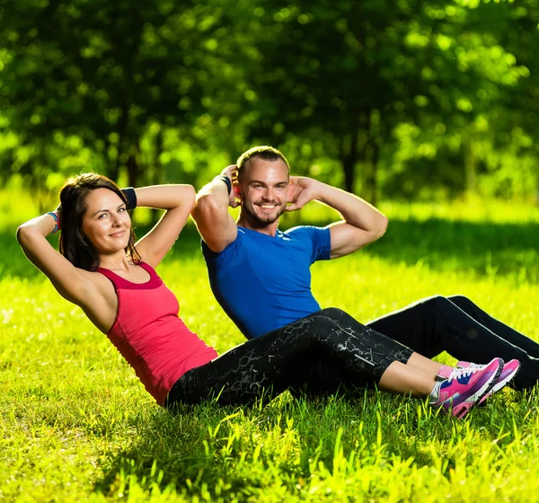 Couple exercising at the city park. Outdoor sport