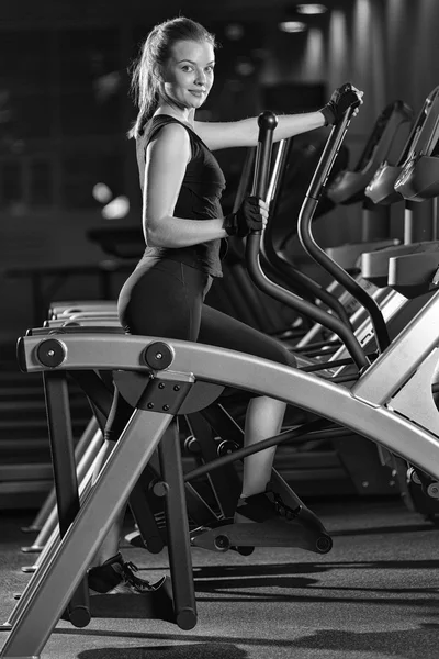 Young woman at the gym exercising. Run on machine.