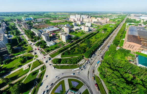 Aerial city view with crossroads and roads, houses buildings. Copter shot. Panoramic image.