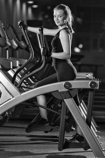 Young woman at the gym exercising. Run on machine.