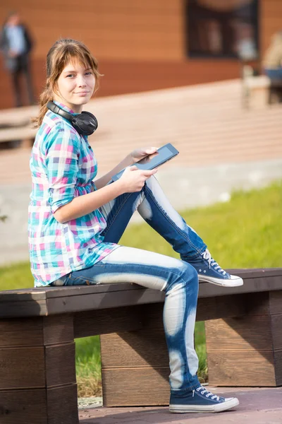 Beautiful young woman student with note pad. Outdoor student.