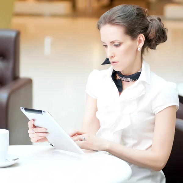 Businesswoman using tablet on in cafe
