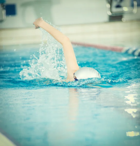 Girl  swimming front crawl stroke style