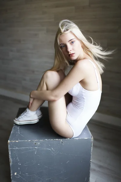 Portrait of beautiful blonde girl in white bodysuit