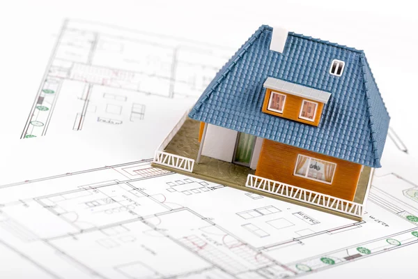 Real estate development - house scale model on blueprints