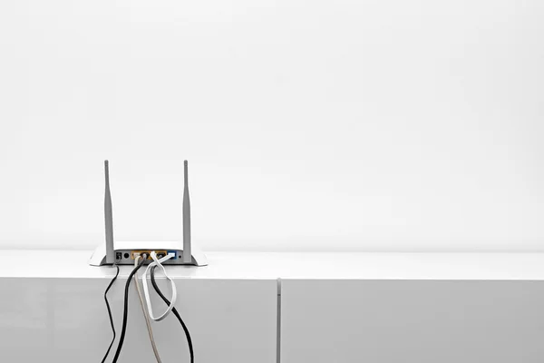 Wifi internet router on shelf in white interior