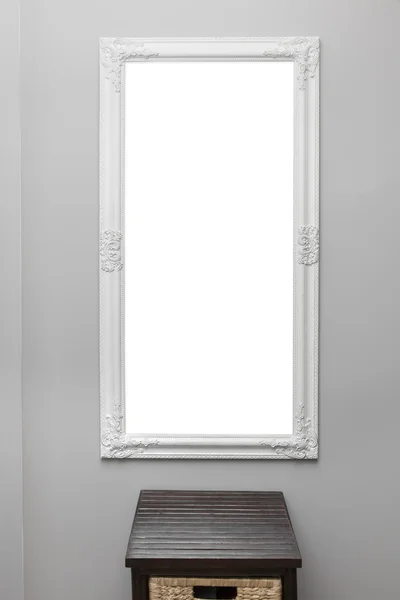 White vintage mirror frame on the gray wall