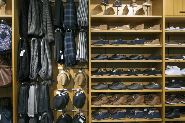 Shelves with shoes and accessories in clothes shop