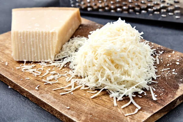 Piece of a parmesan and grated cheese