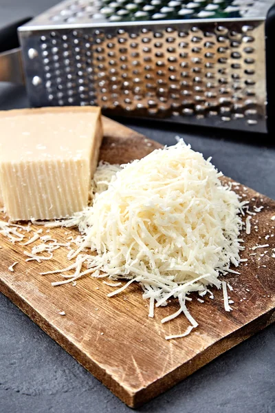 Piece of a parmesan and grated cheese