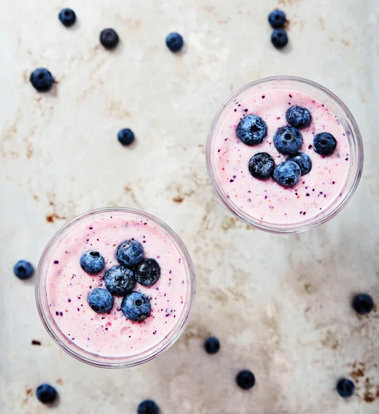 Close-up shot of blueberry smoothie with berries in glass