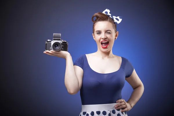 Pin Up girl holding a vintage camera