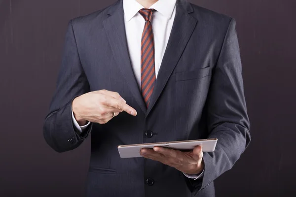 Businessman pointing to digital tablet