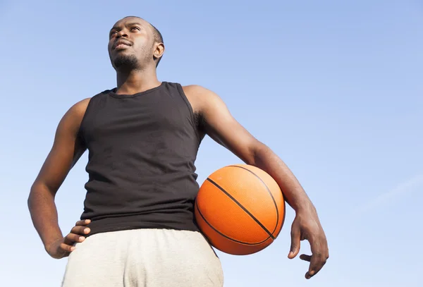 Afroamerican man street basket player holding a basketball