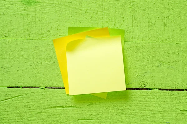 Sticky notes isolated on wooden background