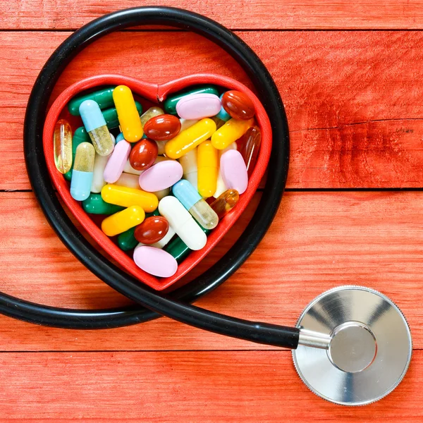 Pills in heart box and Stethoscope