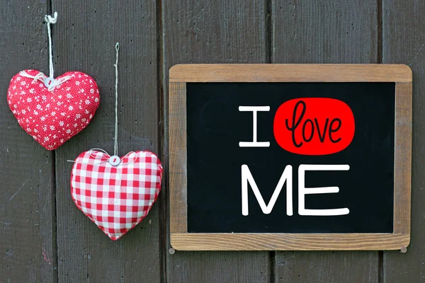 Blackboard with I love me and hearts