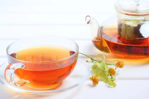 Tea teapot cup herbal wood background