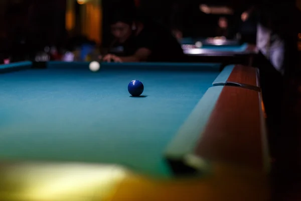 People playing pool in a bar