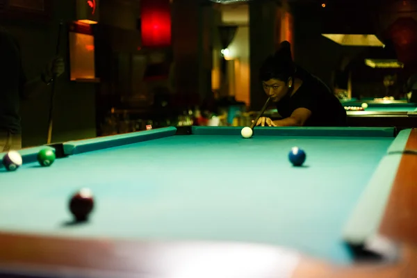 People playing pool in a bar