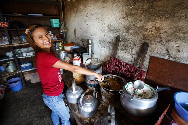 Girl cooking Burmese food in Falam town