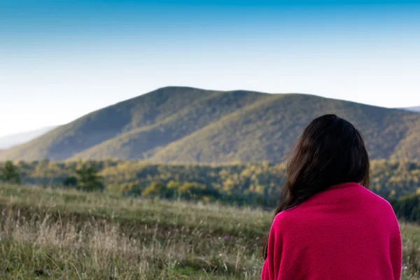 Girl looking afar on the Carpathians Mountains background