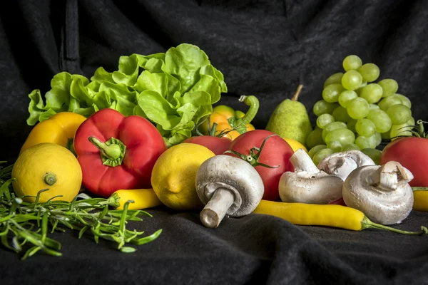 Colorful mix of fruits and vegetables, black background