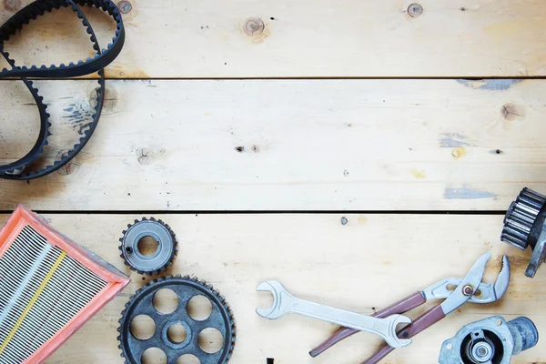 Wooden background with automobile spare parts