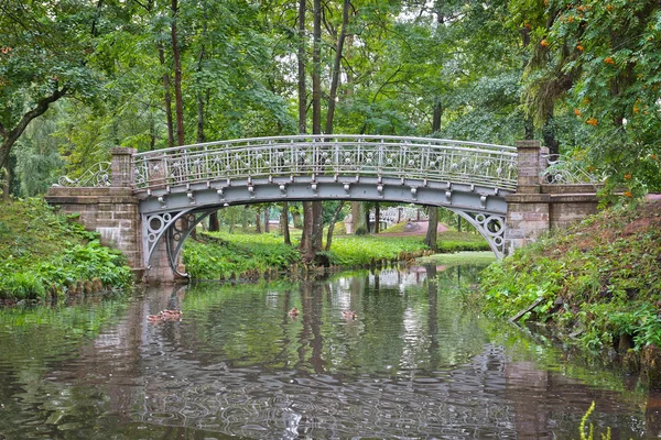 Old bridge over water in the palace park in Gatchina