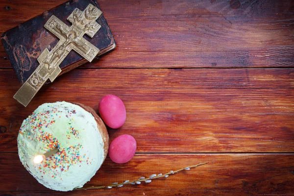 Composition about Orthodox Christian Easter with red eggs and burning candle over the cake