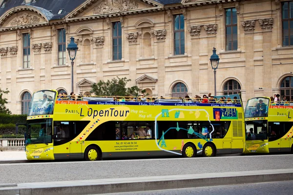 Yellow city sightseeing bus Neoplan on Paris city street.