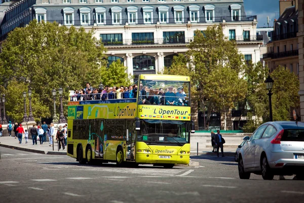 Yellow city sightseeing bus Neoplan on Paris city street.