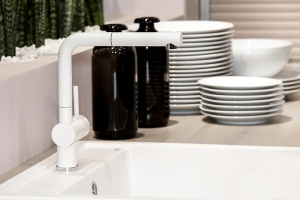 Modern white kitchen sink and faucet