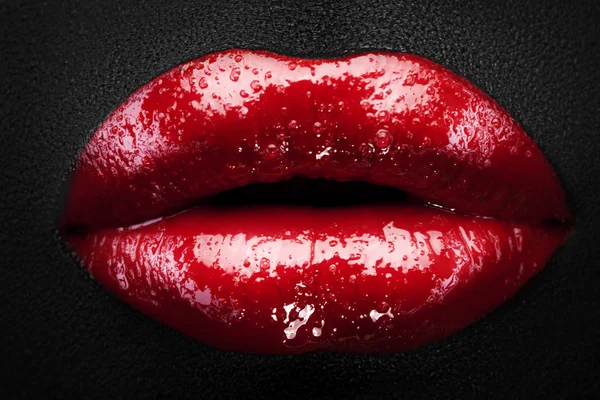 Shiny red lips in drops of water