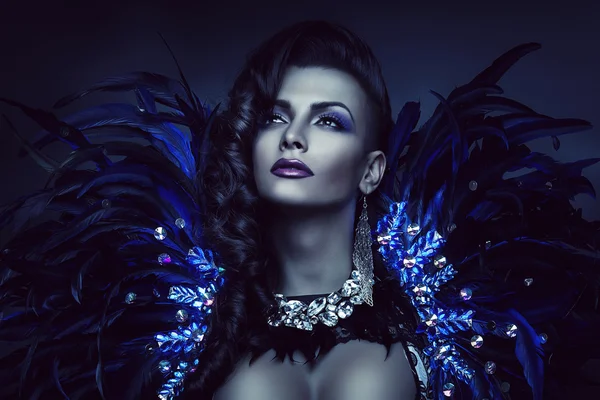 Woman in blue feather