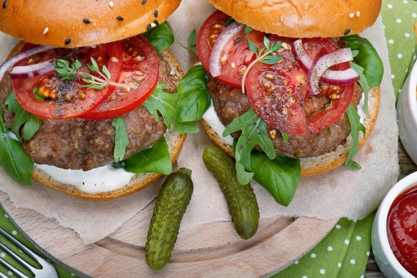 Hamburgers with beef patties and salad ingredients