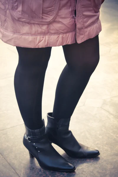 Girl with black boot and stocking wearing pink jacket - retro st