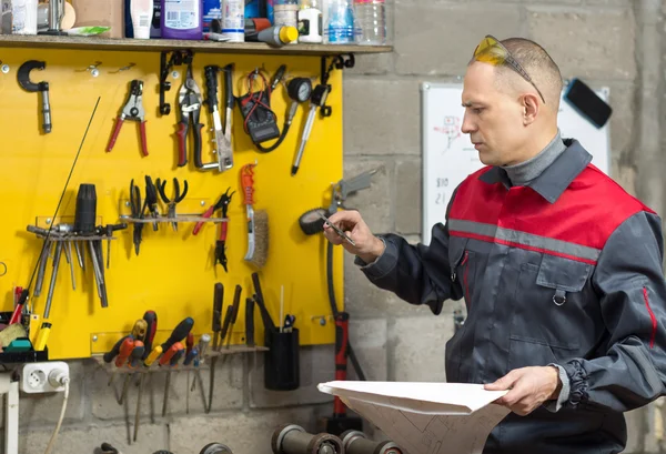 Mechanic worker studying his instructions