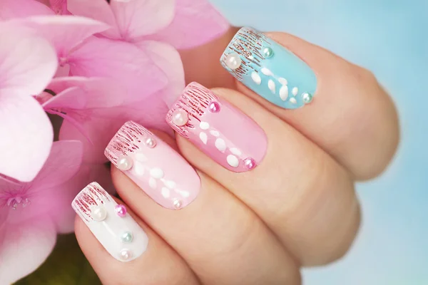 Colored manicure with hydrangea.