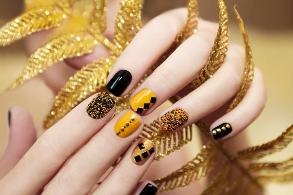 Yellow black manicure .